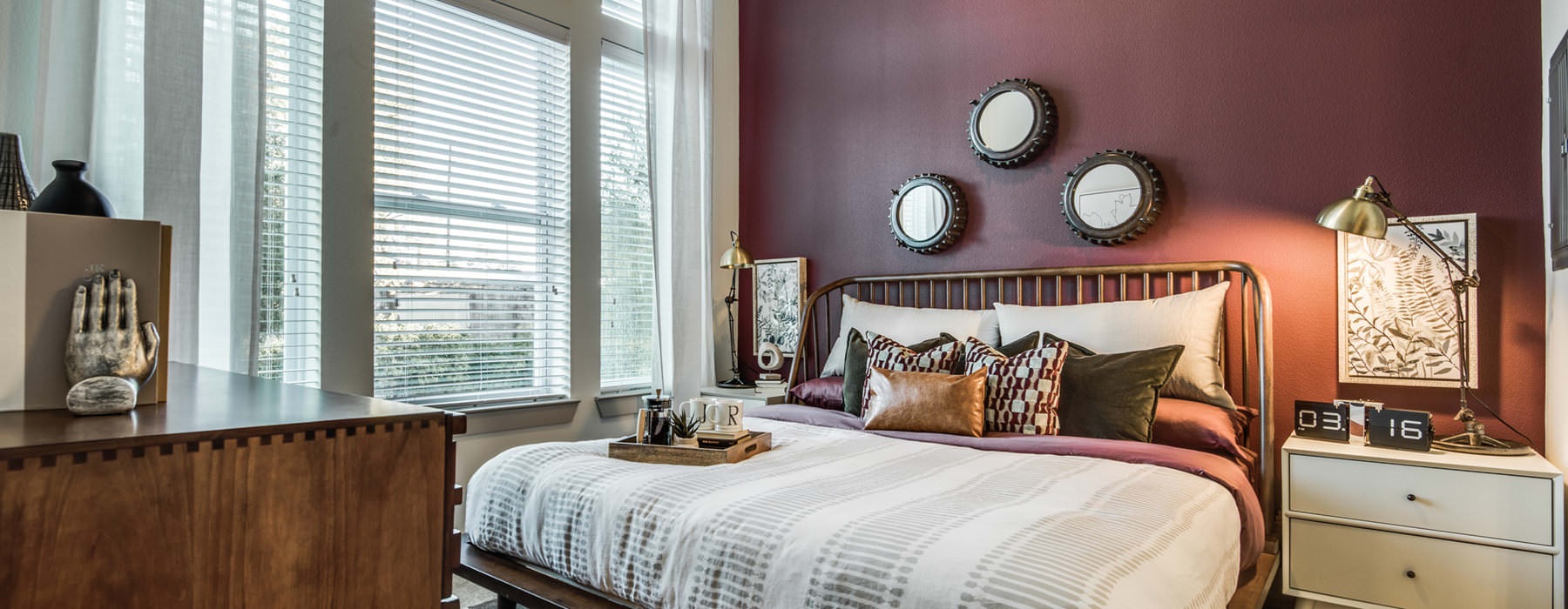 furnished, carpeted bedroom with large windows